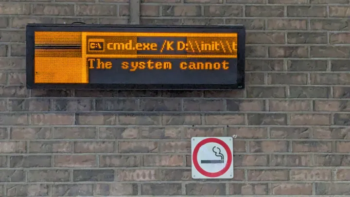 A broken railway information display, saying "The system cannot"
